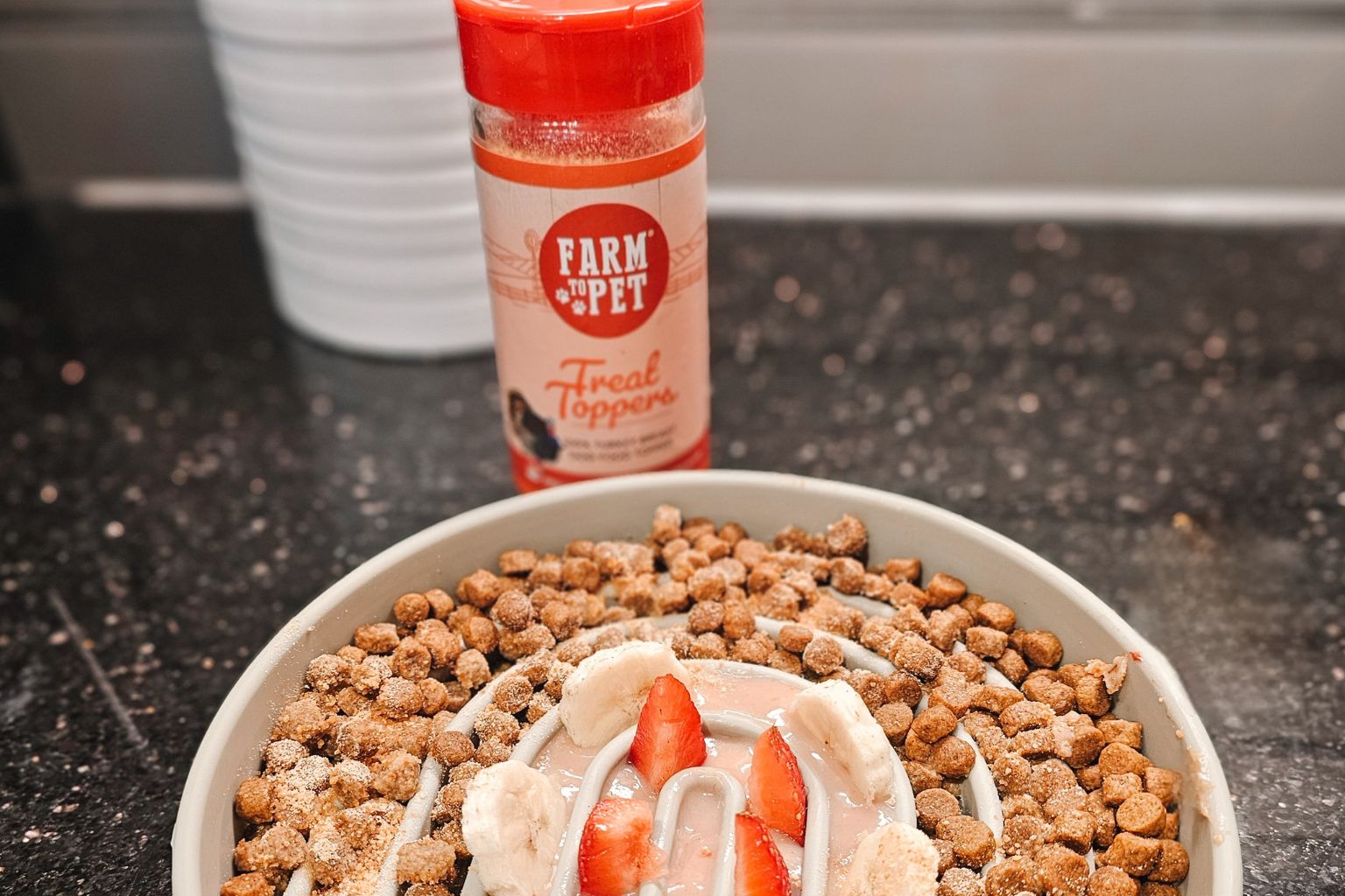 a dog food parfait in a slow feeder next to a farm to pet turkey dog food topper jar